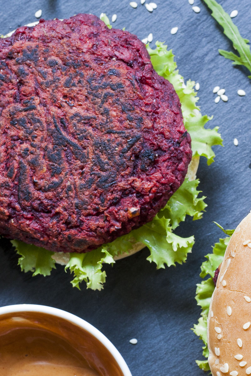 Photo of a purple burger from above on a black slate board