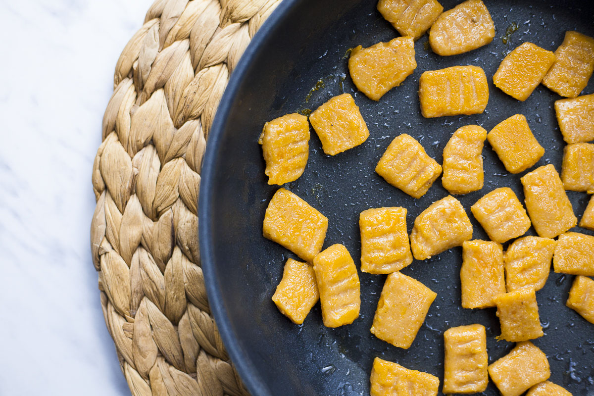 Several soft orange rectangle-shaped in a black frying pan.