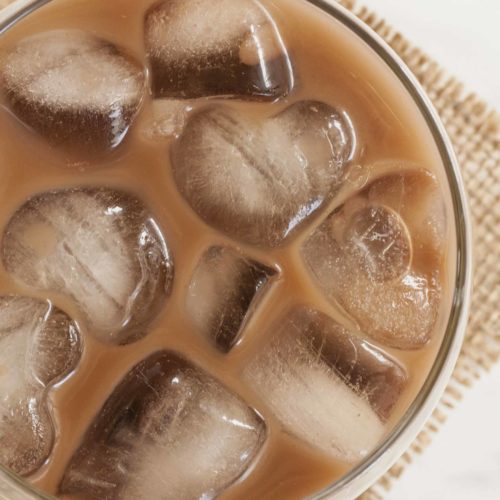 Close-up of a glass full of Vegan Baileys made of coffee, Irish whiskey, cane sugar, almond milk, and a bit of vanilla extract and cocoa powder.