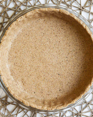 Glass pie pan with brown unbaked pie crust