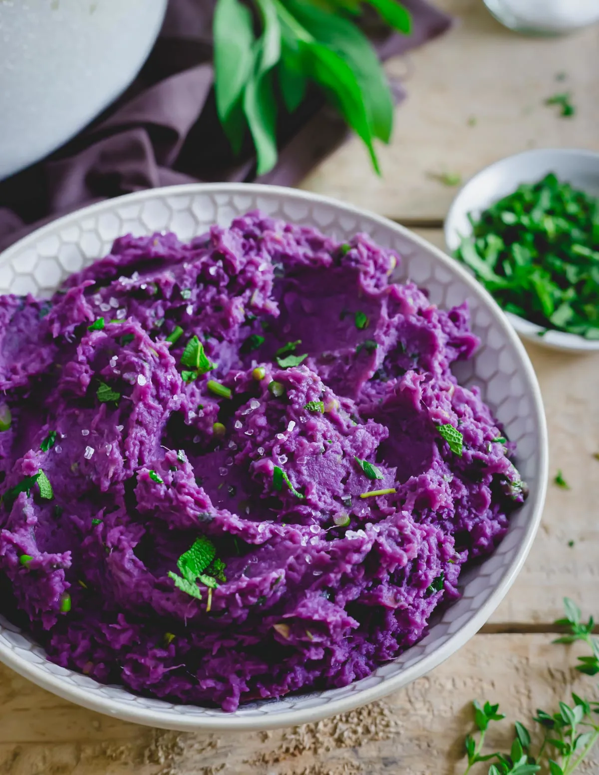 A small white bowl with vibrant purple mash. 