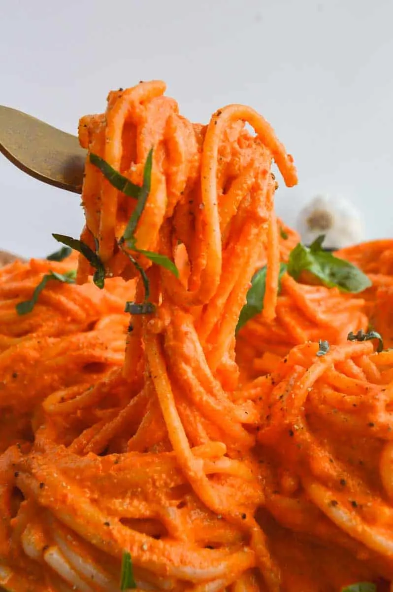 Red pasta sauce on spaghetti. A fork is lifting some up in the air.