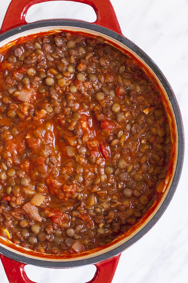 Red dutch oven with lentil bolognese ragu