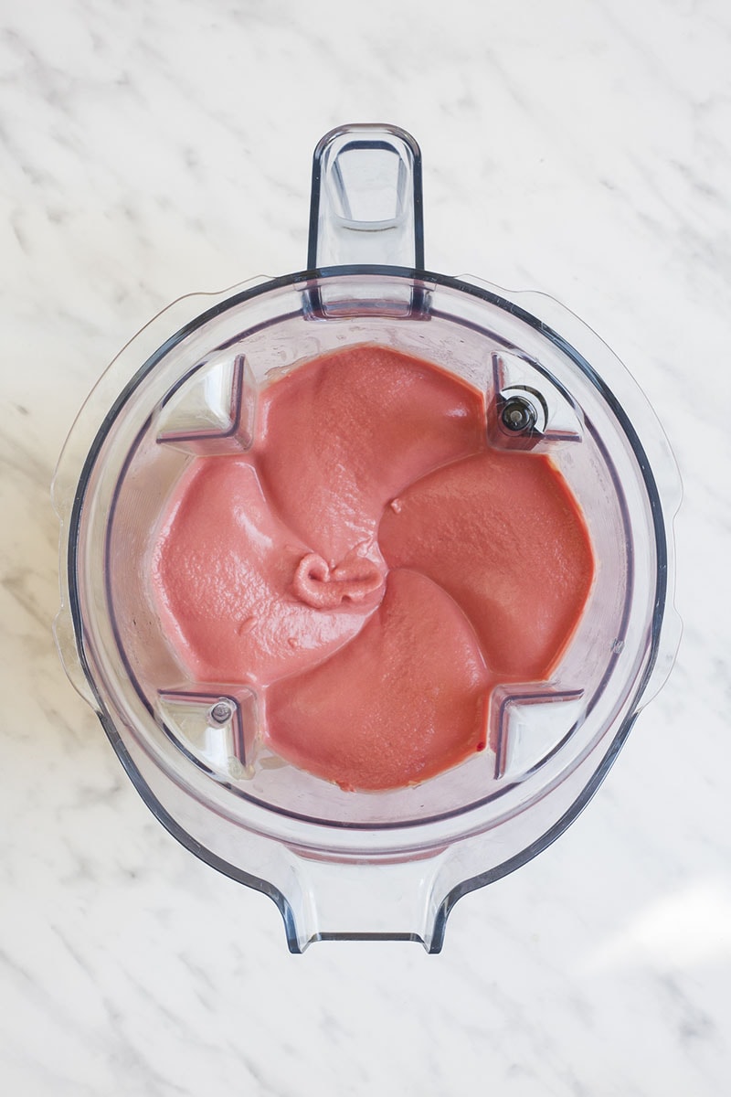 Blender from above with creamy pink beetroot hummus