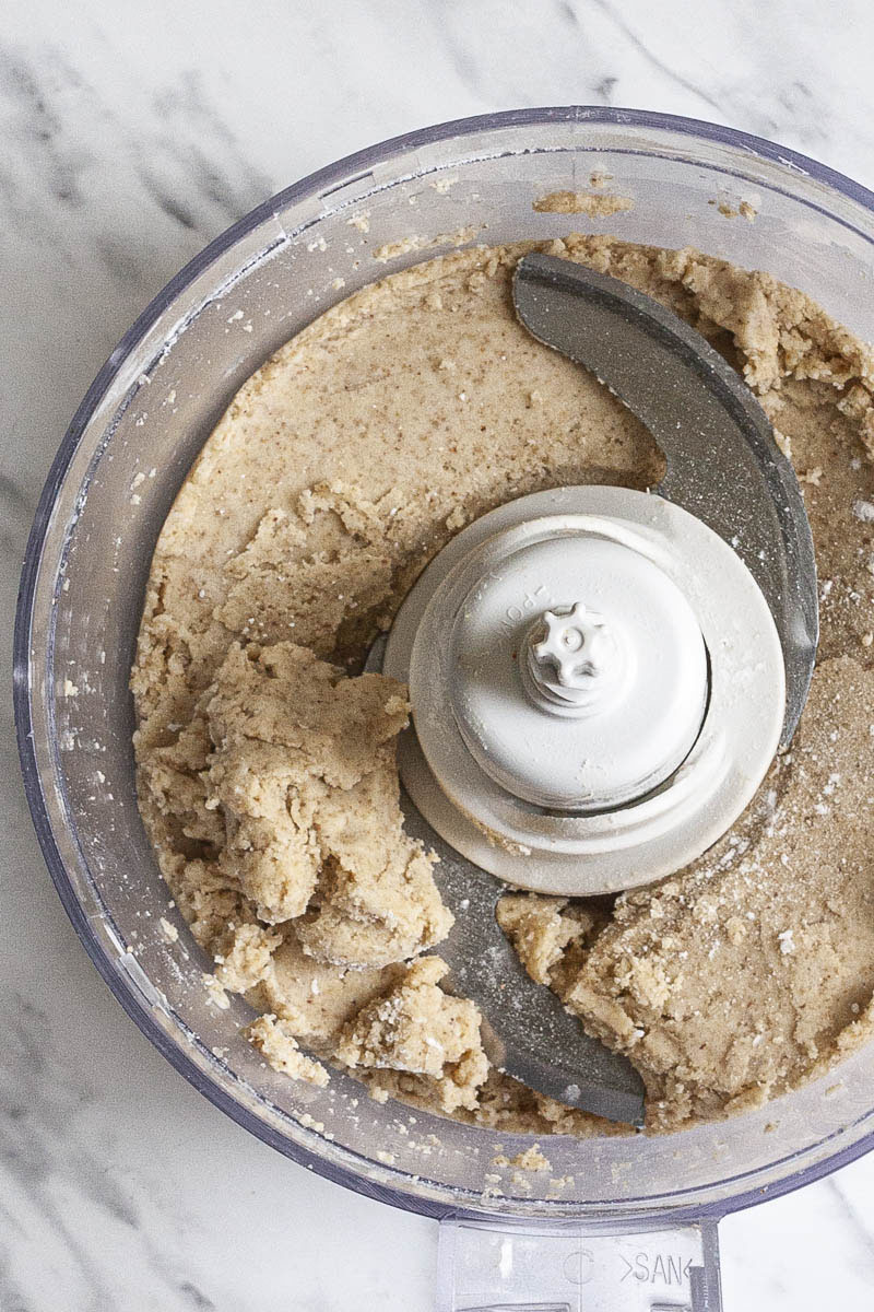 Food processor from above with a mixed dough