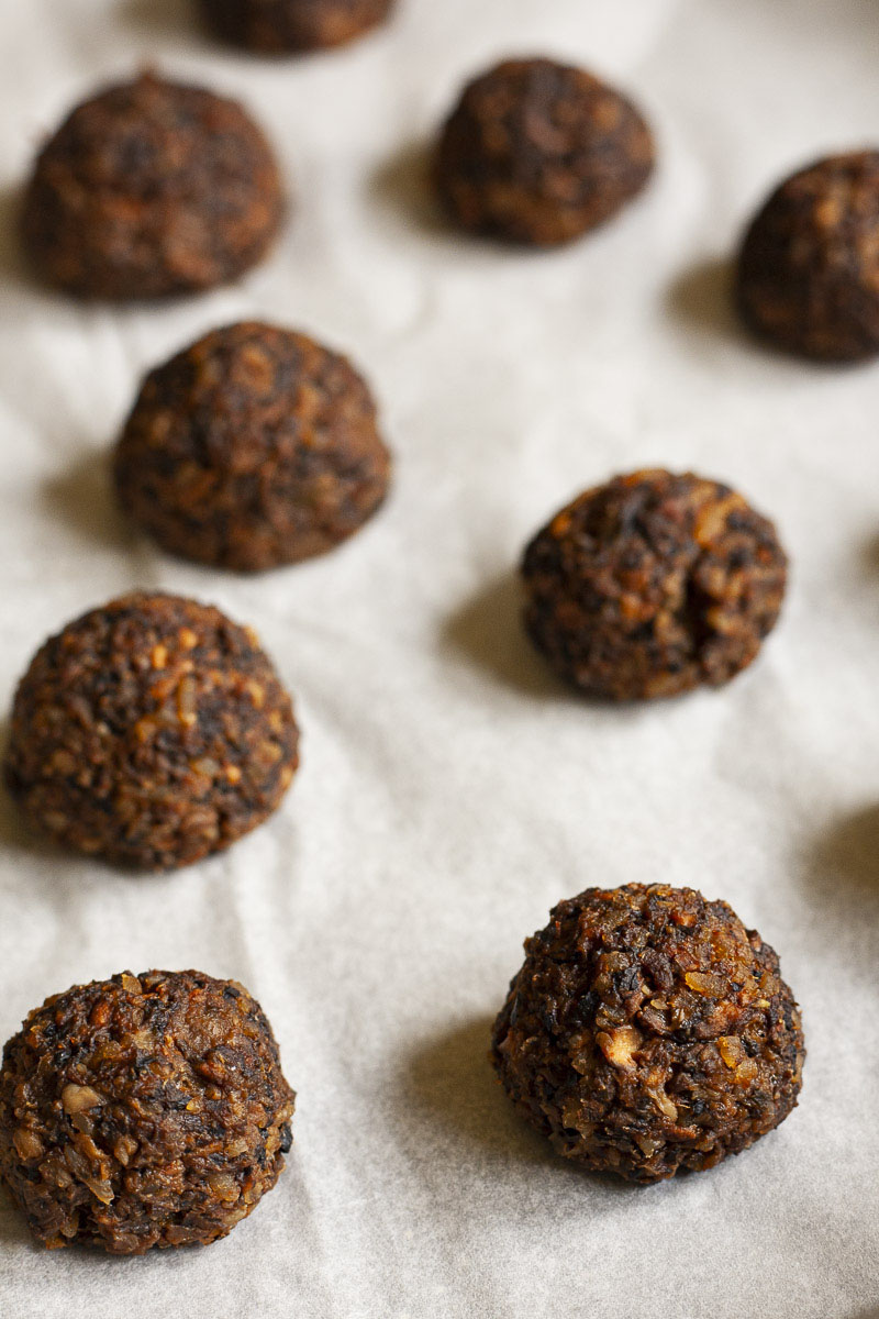 Several mushroom meatballs of brown yellow color on a parchment paper after baking