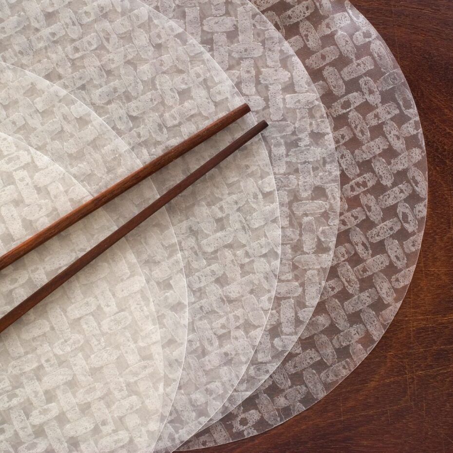 A couple of round rice papers on a wooden surface