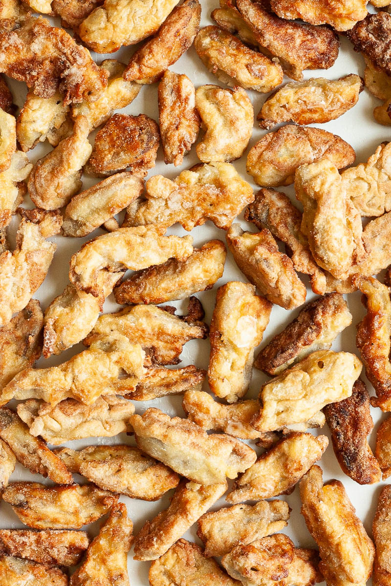 Light brown crispy strips from above on a parchment paper.