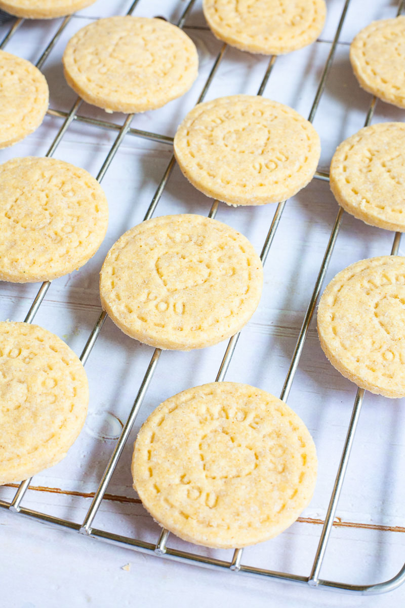 Thin round cookies on wire rack.