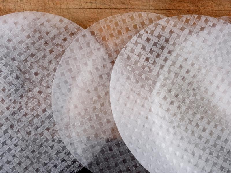 Round rice papers on a wooden surface