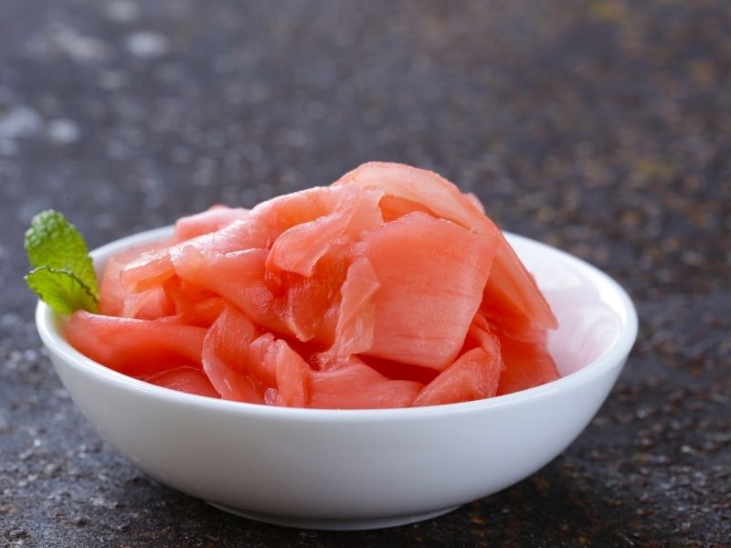 pink sliced pickled ginger in a small white bowl