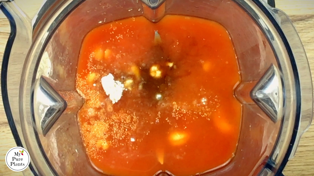 A blender from above with a reddish liquid.