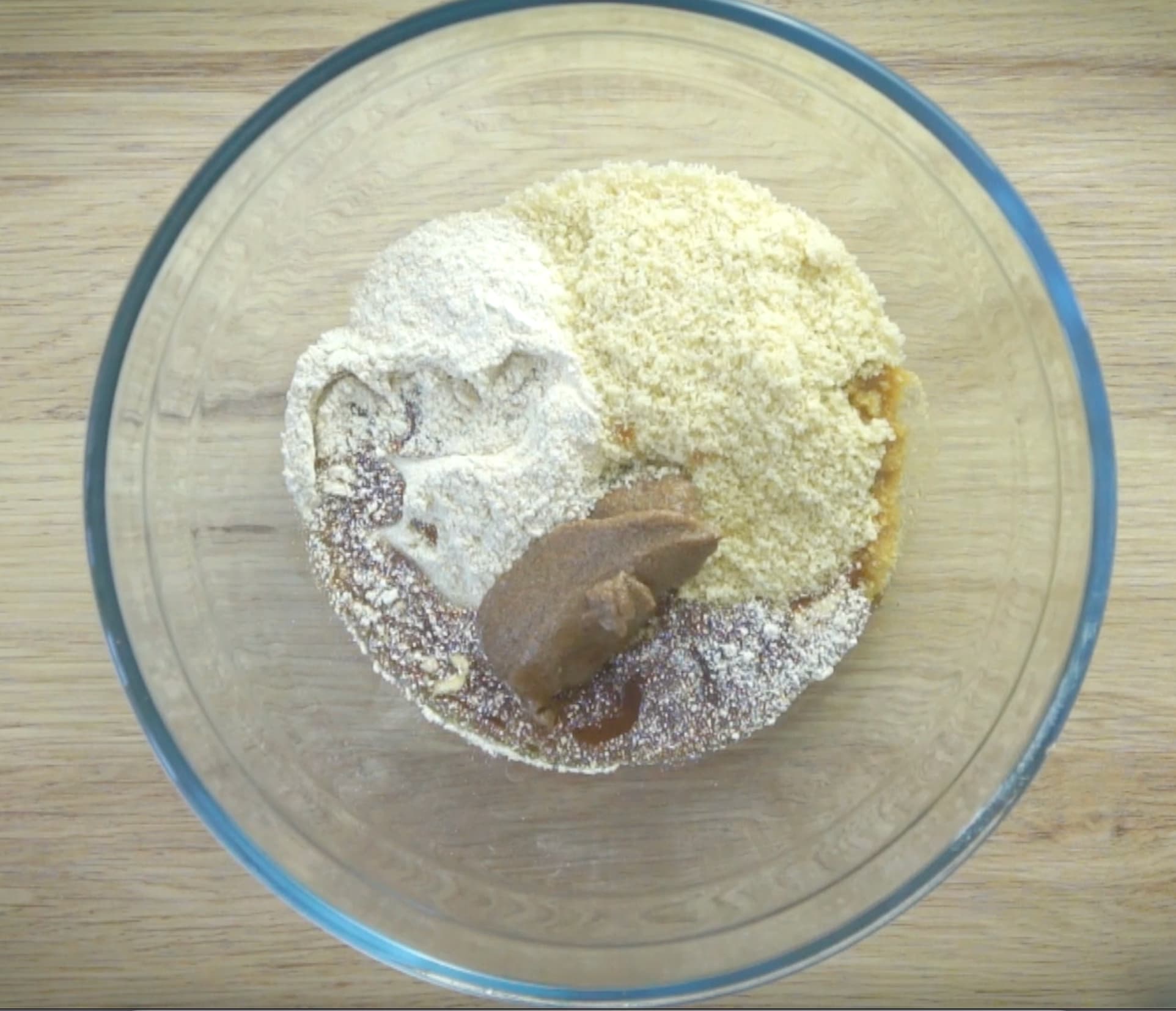 A glass bowl with flour, nut meal and ground flax seeds paste. 