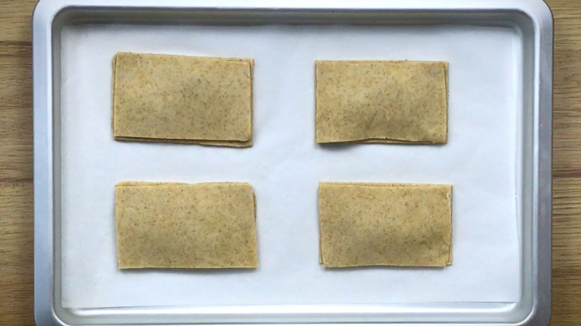 4 rectangular pie dough elevated in the middle as if there is something under the top layer.