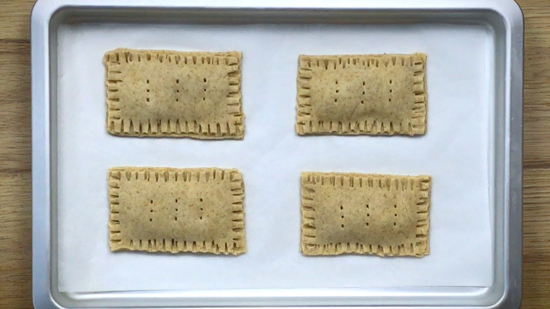 4 rectangular pie dough sealed on the sides and have holes in the middle.