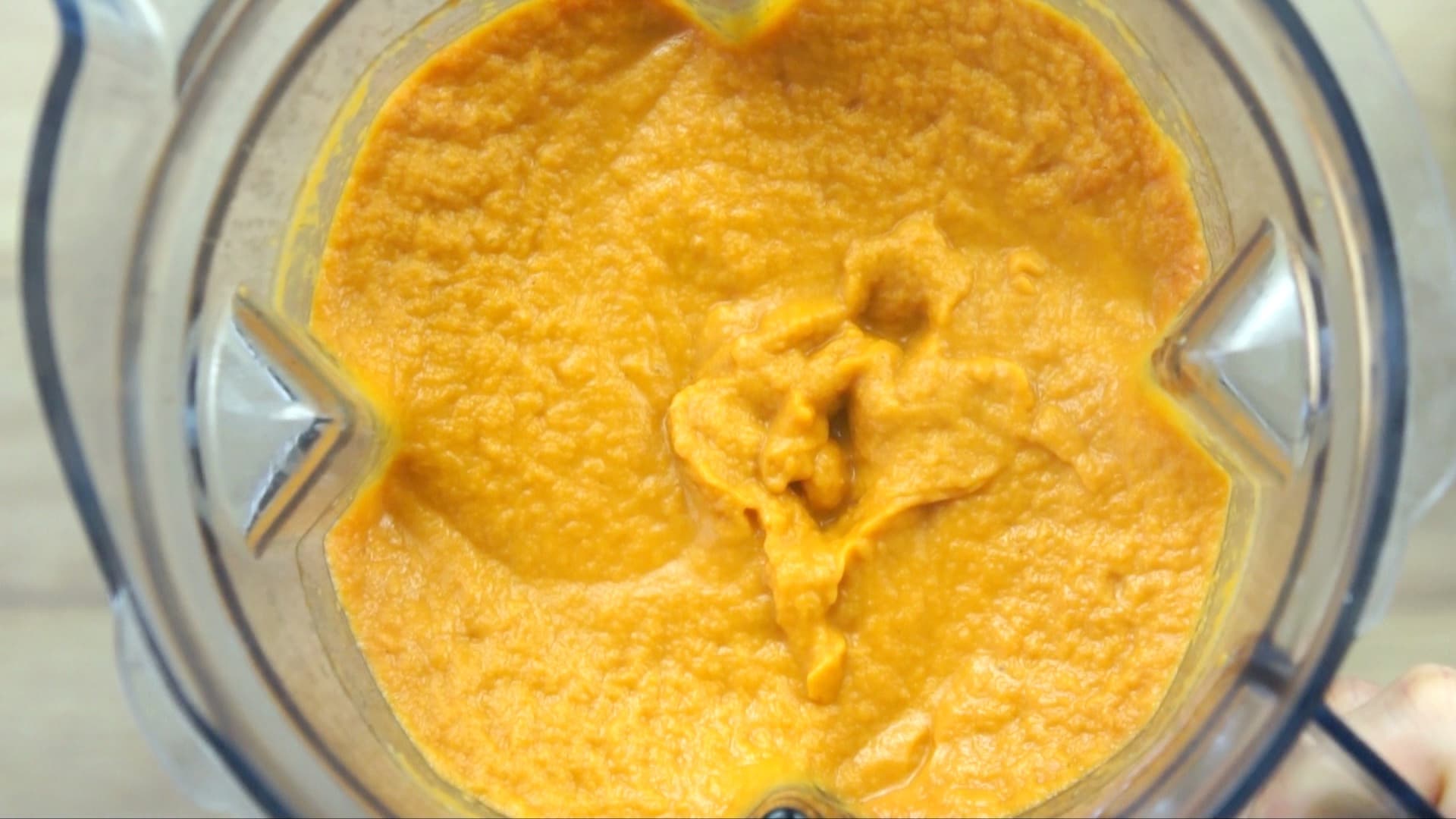 Thick orange sauce in a blender.