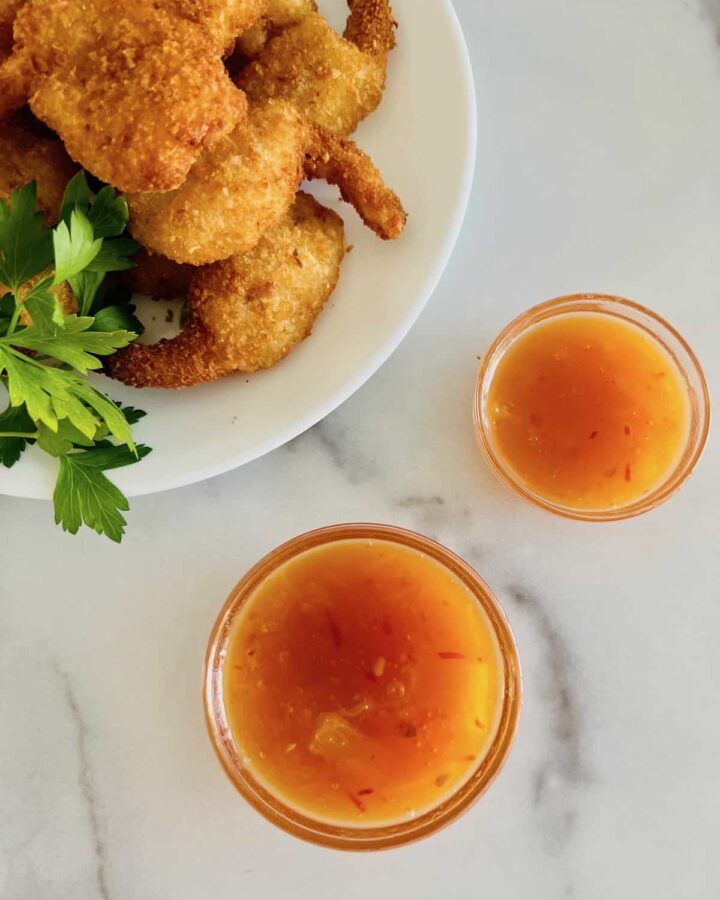 Two small glass bowls with an orange-brown sticky sauce.