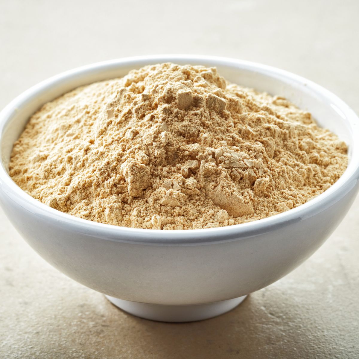 Yellow powder in a small white bowl. 