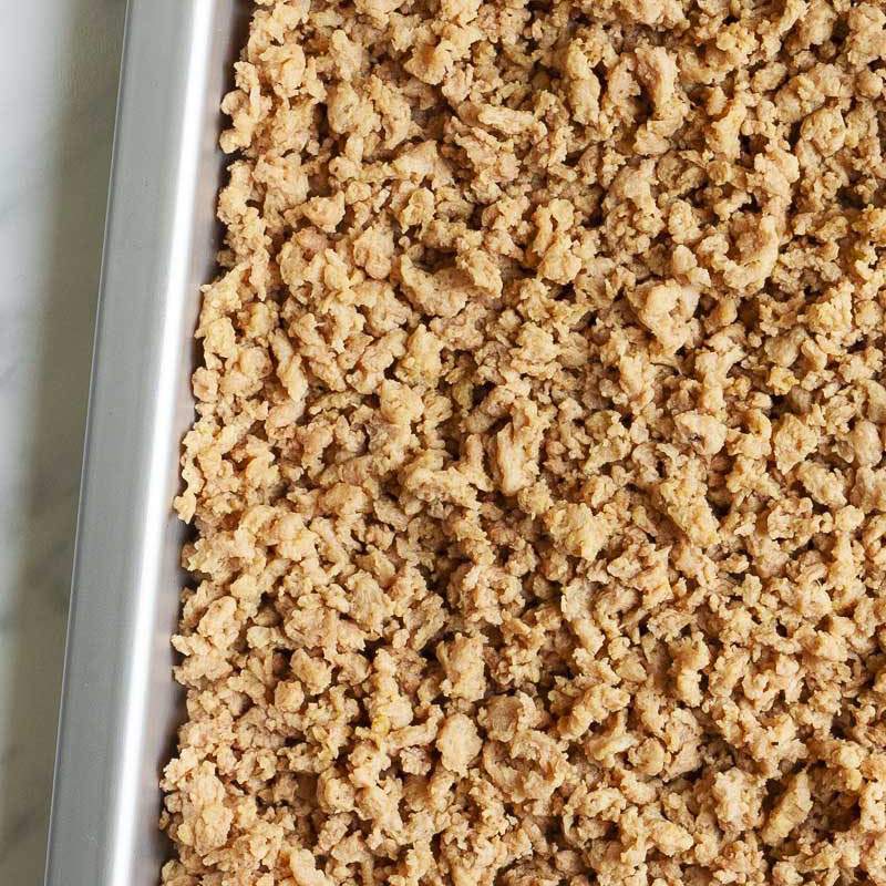 Light brown crumbles on a silver tray.