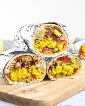 3 half tortillas wrapped in tin foil filled with sausage crumbles, diced potatoes, tofu scrambles, and avocado tomato salsa.