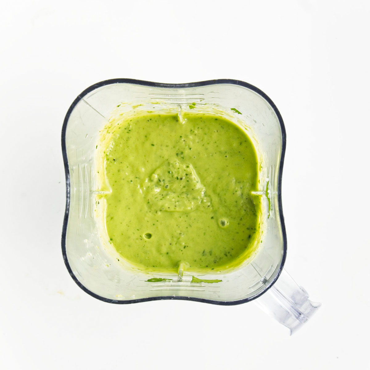 Blender with a vibrant green soup