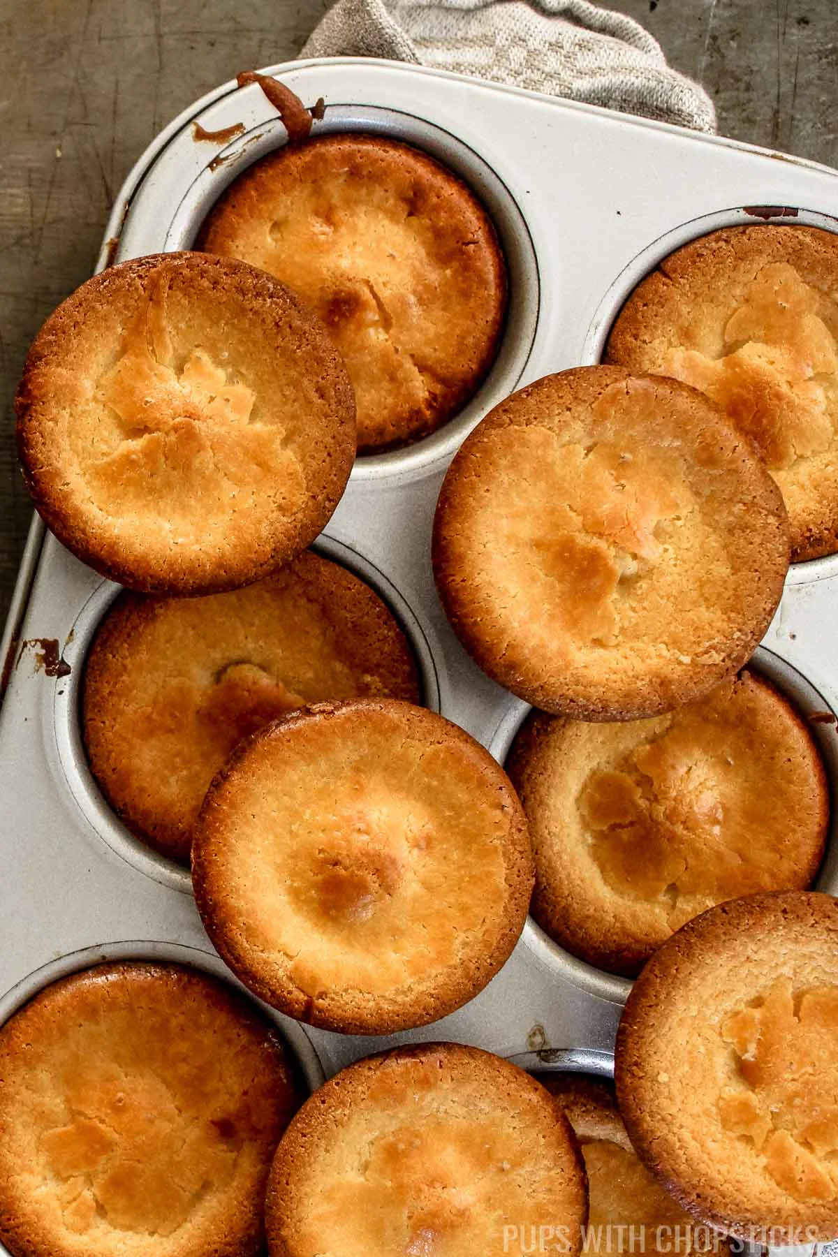 A pan full of muffins sitting on top of a table.