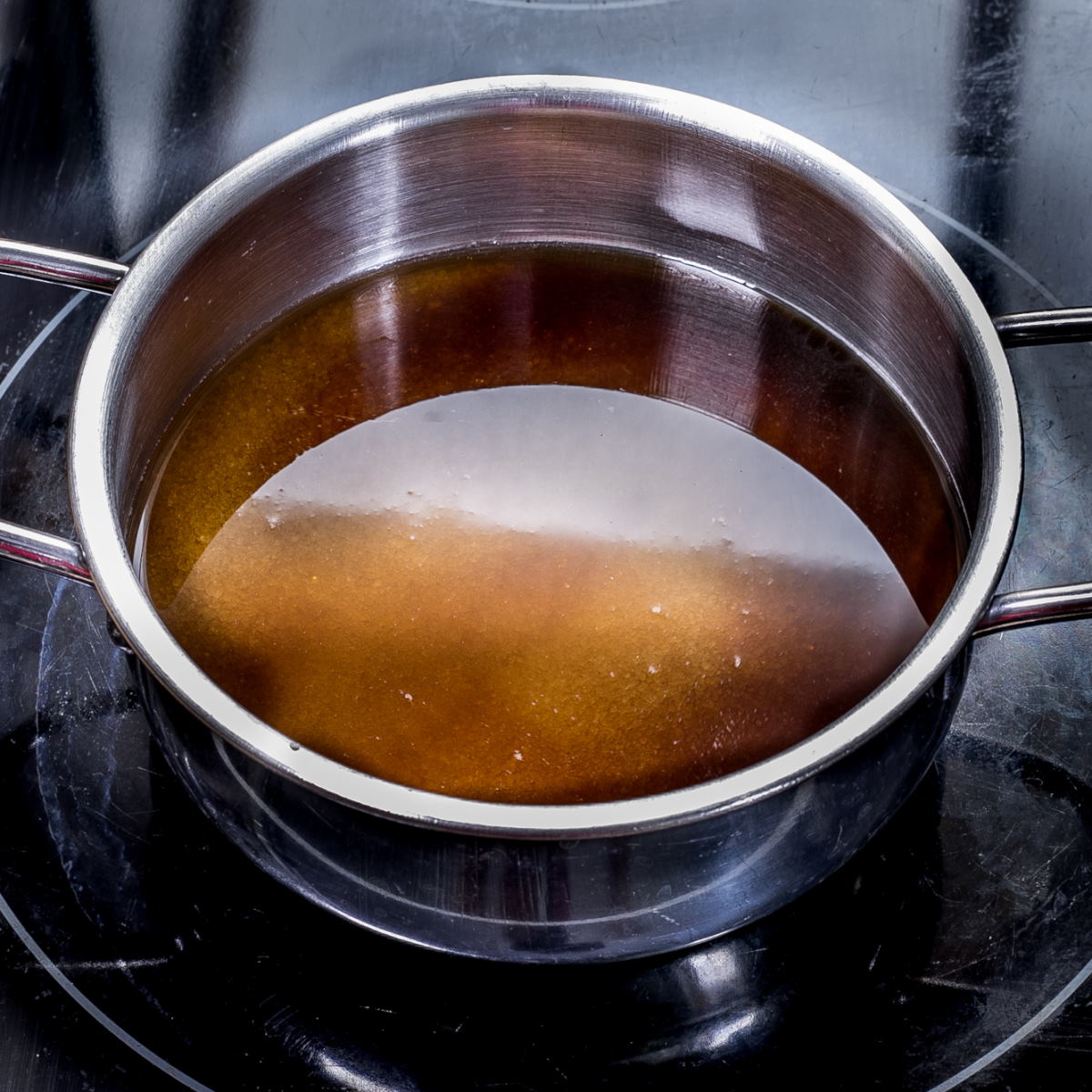 Small pot with dark amber liquid.