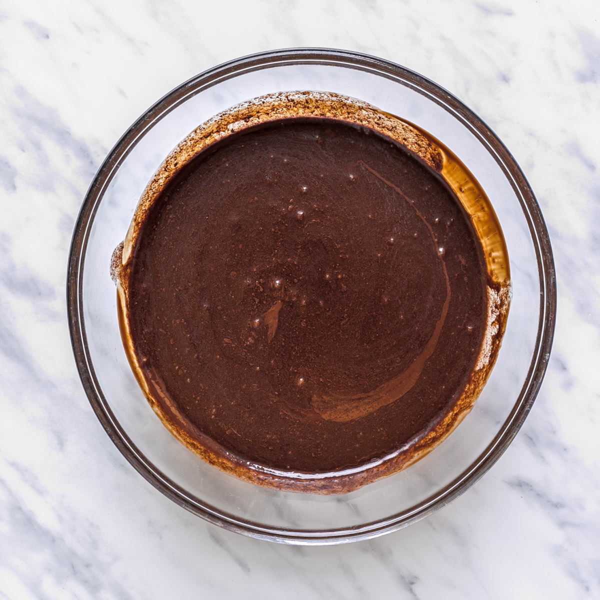 Melted chocolate in a large glass bowl.