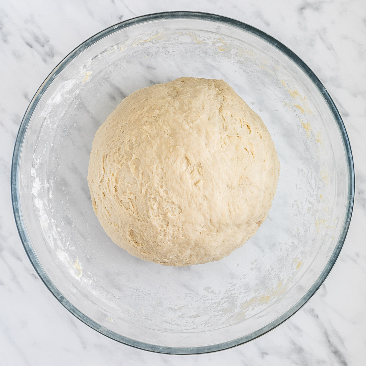 Glass bowl with a ball of white dough