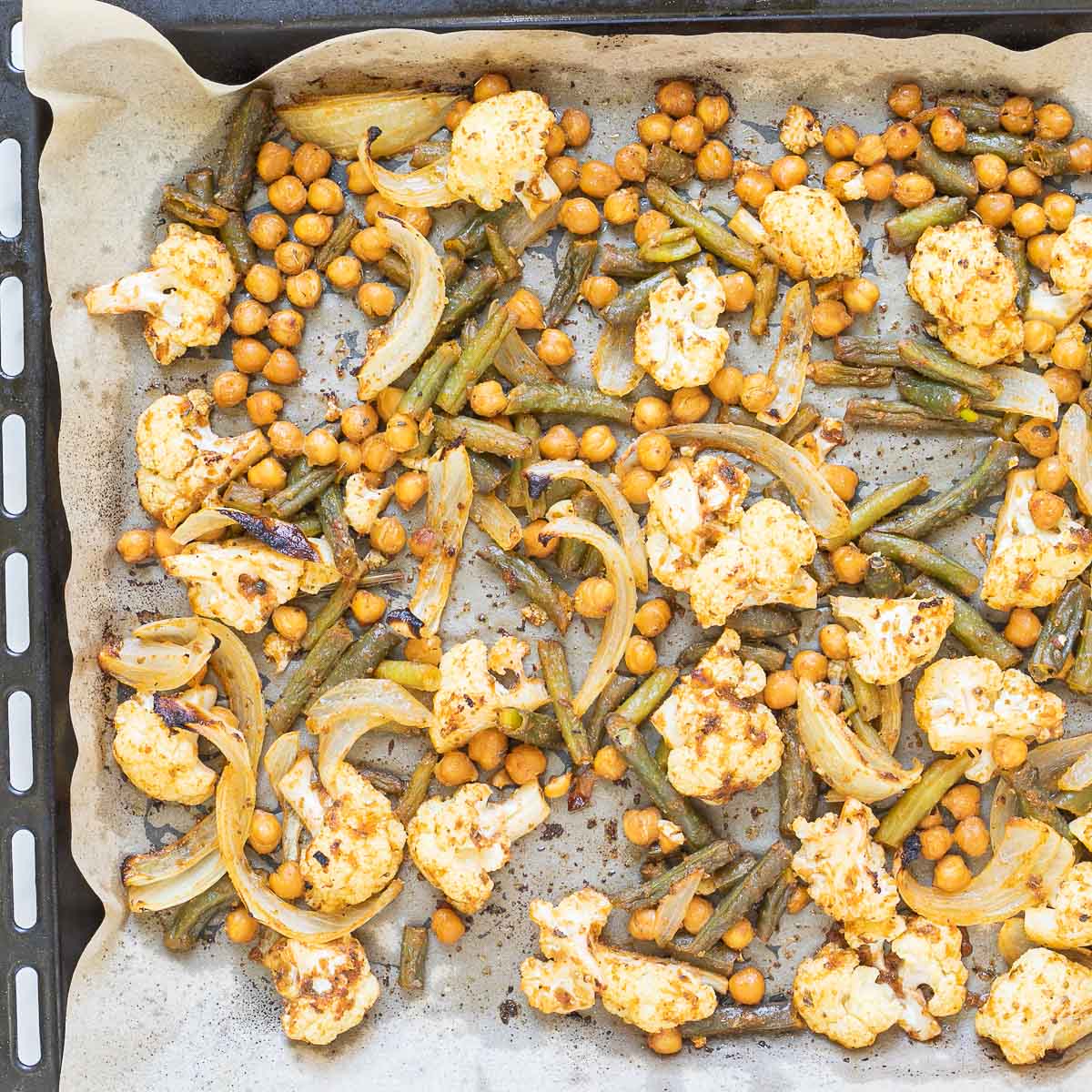 Sheet pan with roasted cauliflower florets, green beans and chickpeas