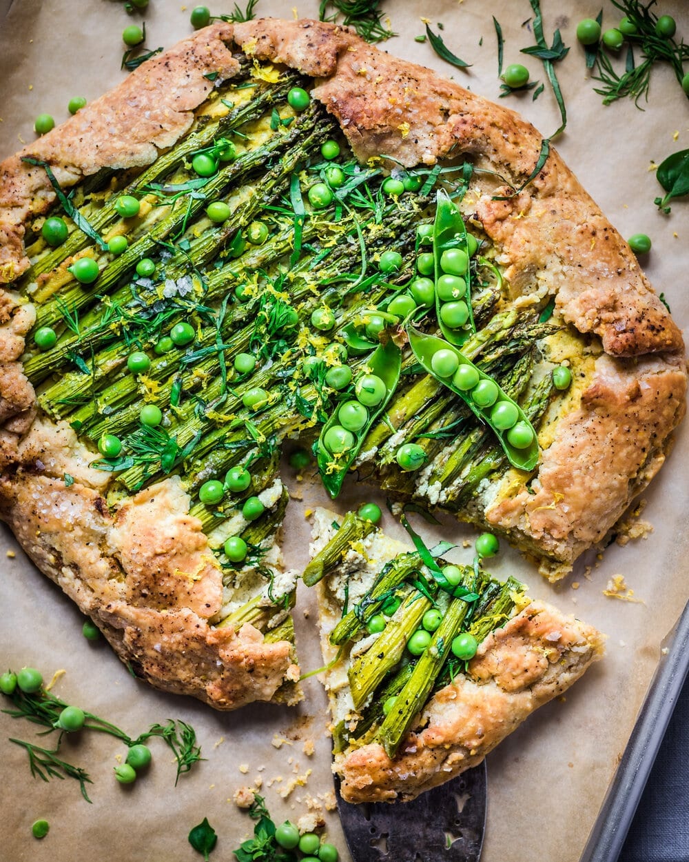 Light brown galette with asparagus and green peas.