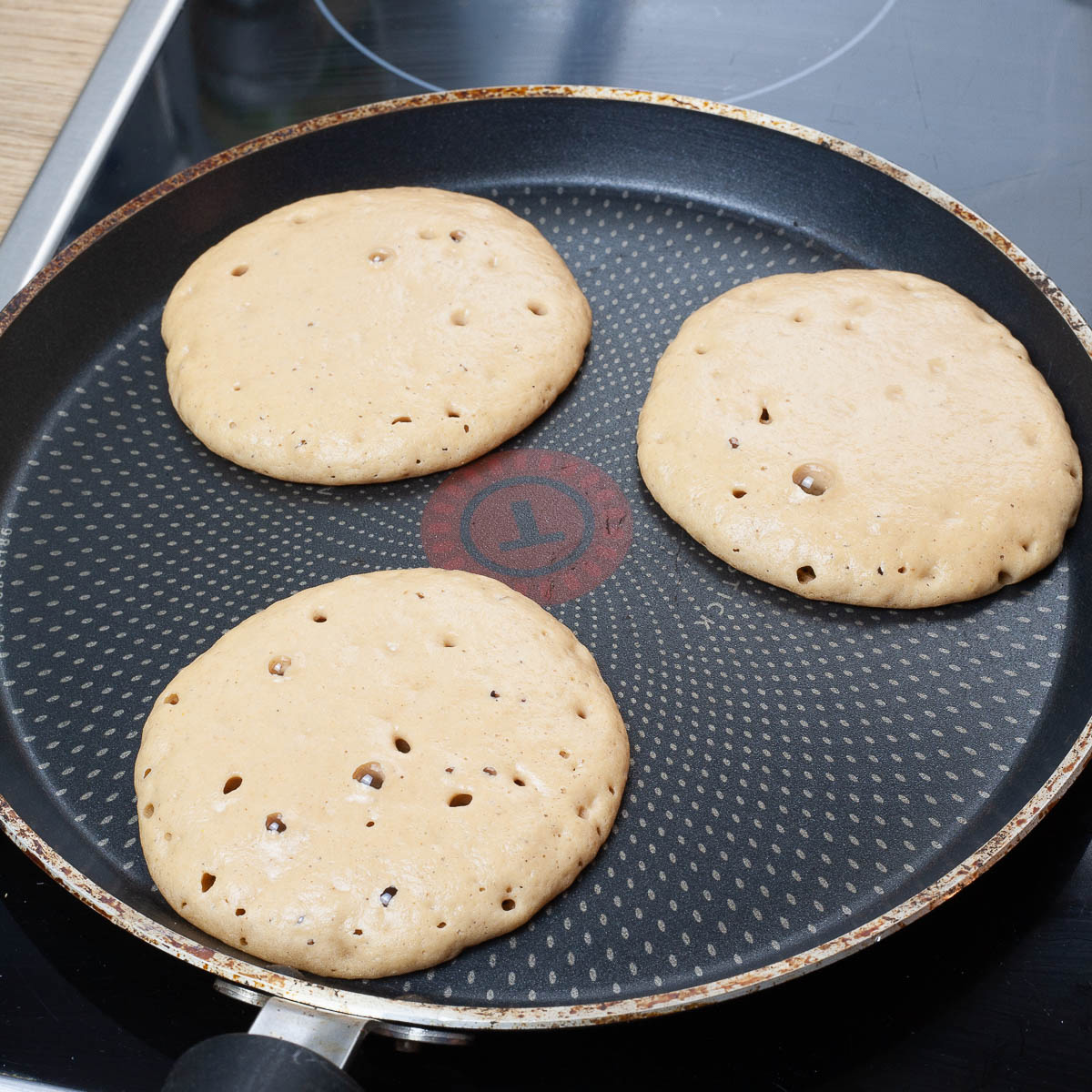Frying pan with 3 pancakes.