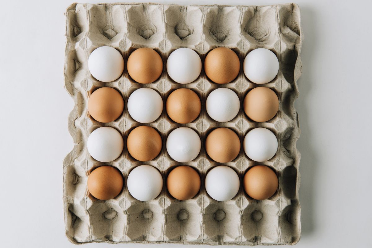 Egg tray with white and brown eggs.