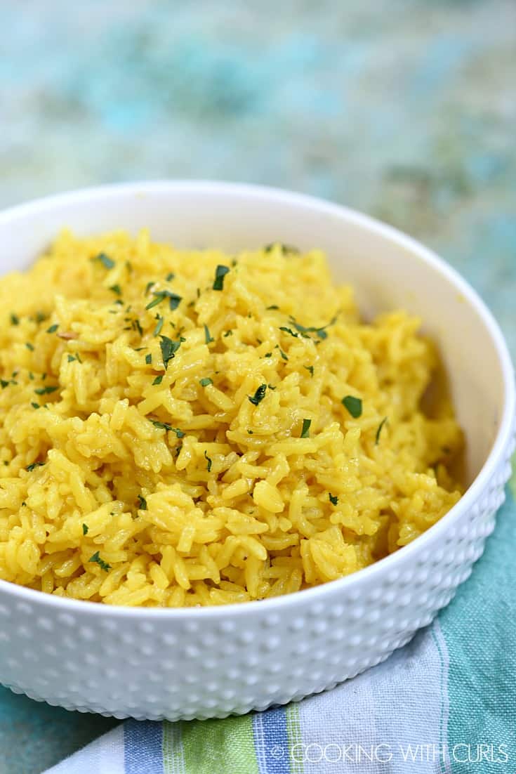 A savory side dish of Yellow Rice, cooked to perfection in an Instant Pot, served in a bowl on a table.