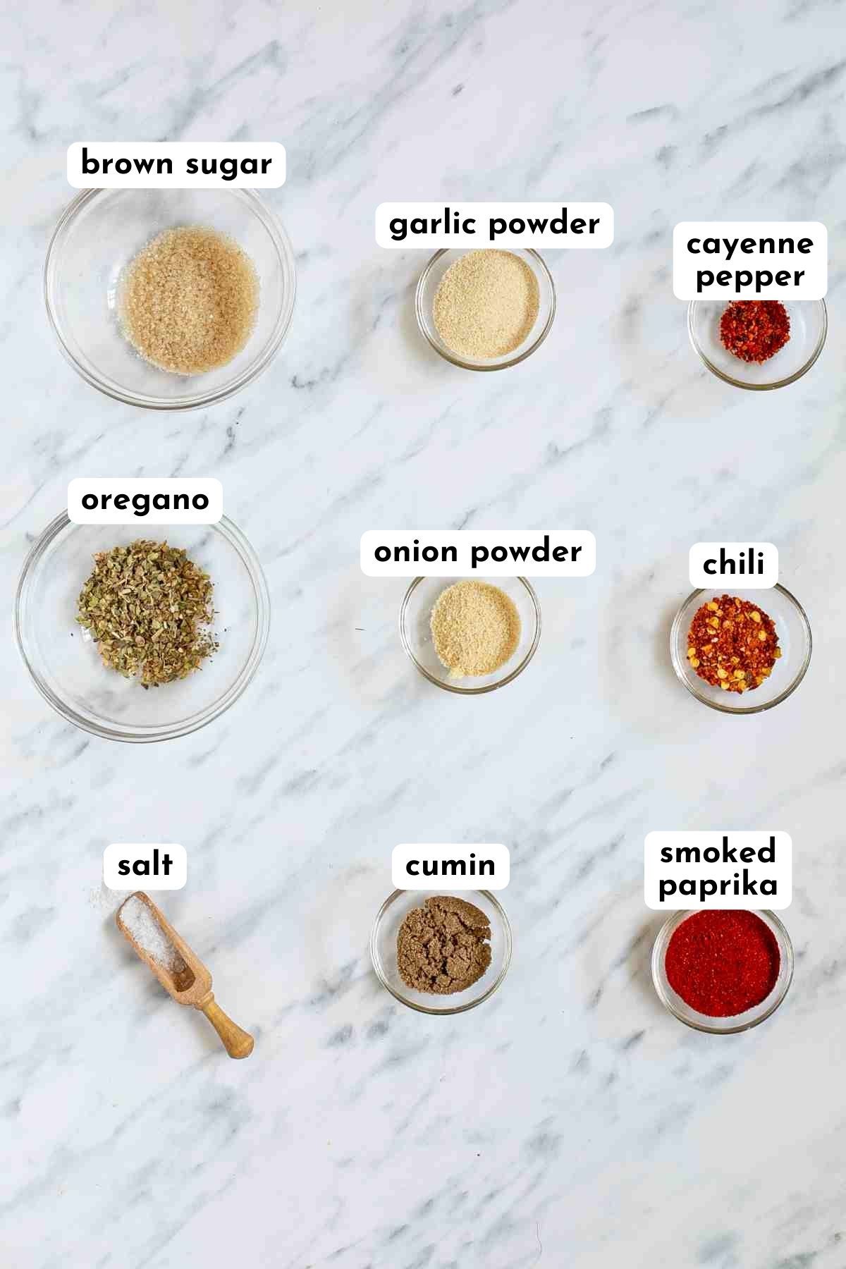 Nine ingredients of fajita seasoning in small glass bowls.