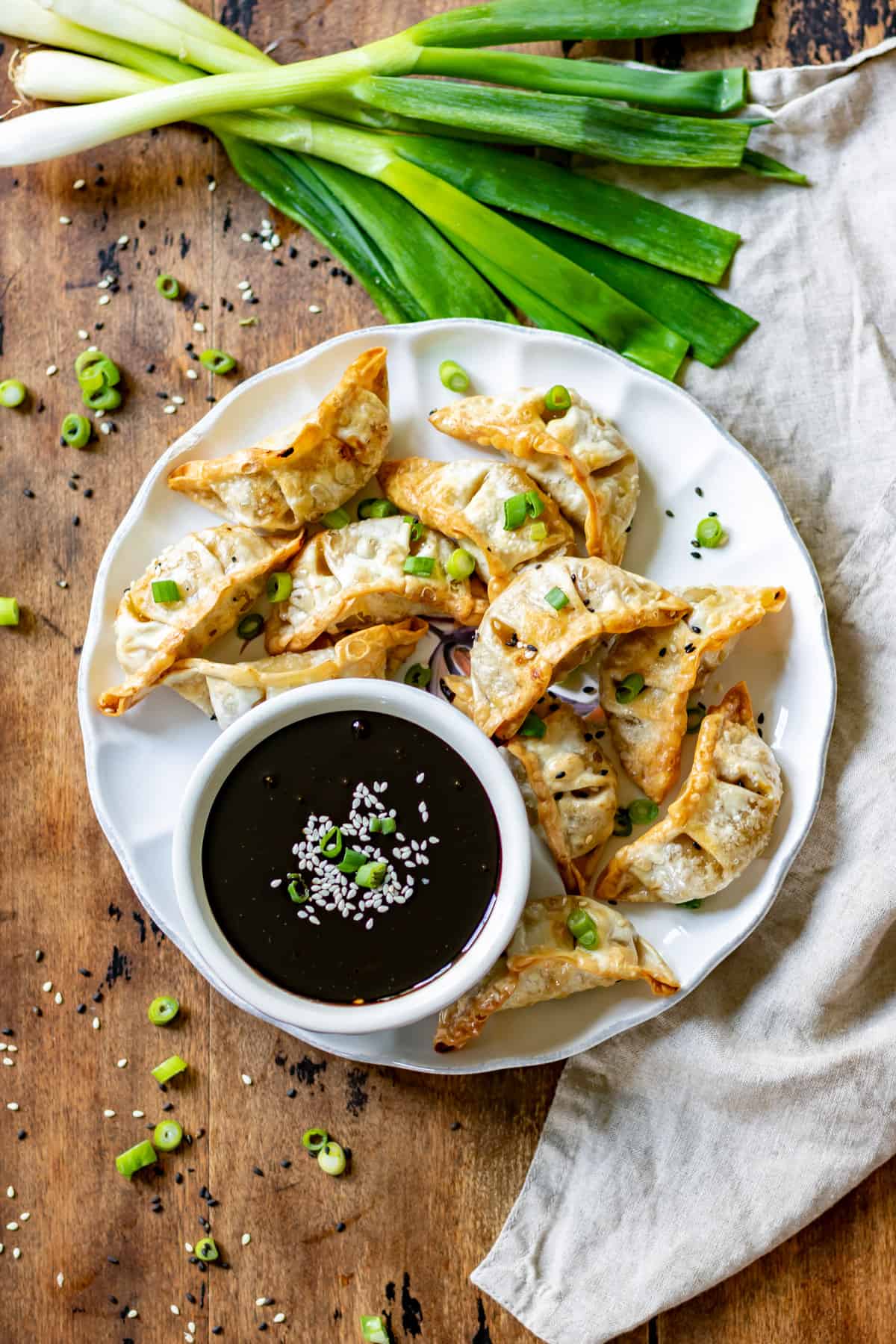 Table with amai sauce in a bowl next to gyoza. 
